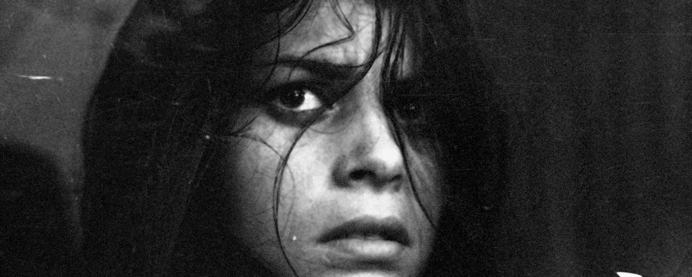 Monochrome close-up of a tense woman's face with a distressed expression.