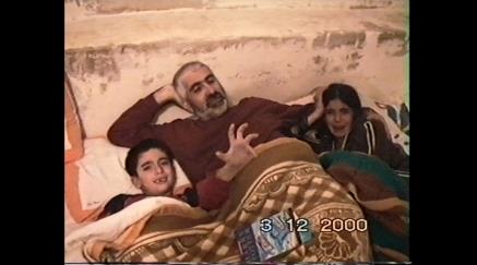 Man with two kids in bed distressed, dated 3 Dec 2000.